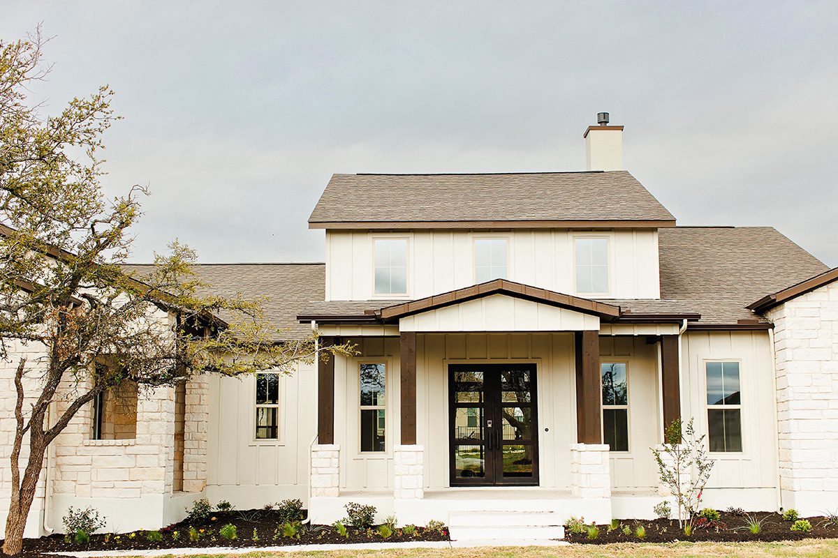 Bunker Ranch neighborhood street lined with mature oaks, Dripping Springs TX